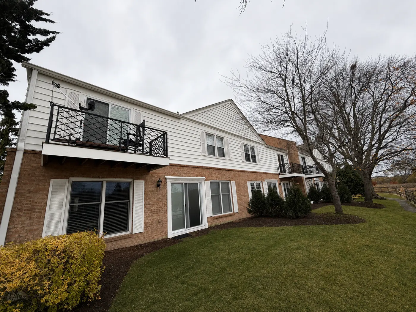 Exterior Painting project — White Siding & Brick Exterior